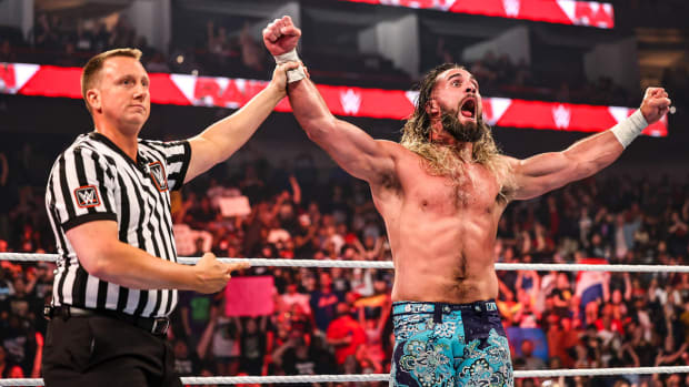 Seth Rollins celebrates after winning a match